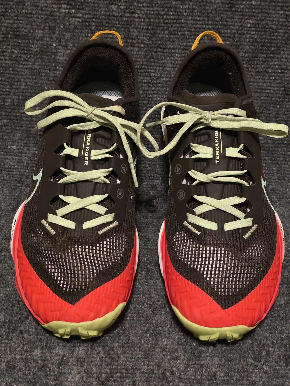 Nike Women's Black Running Shoes with Red and Light Green Accents